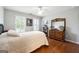 This bedroom features natural lighting, wood floors, and a large closet at 151 Overhill Point, Alpharetta, GA 30005