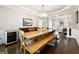 Elegant dining room with a large wooden table, chandelier lighting, and dark wood floors at 151 Overhill Point, Alpharetta, GA 30005