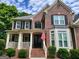 Welcoming front entrance with classic brickwork and a covered porch with black shutters at 151 Overhill Point, Alpharetta, GA 30005