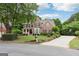 Traditional brick home with lush landscaping, long driveway, and basketball hoop at 151 Overhill Point, Alpharetta, GA 30005