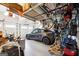 Garage with storage racks, epoxy flooring, and an electric vehicle at 151 Overhill Point, Alpharetta, GA 30005