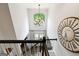 Bright and airy hallway with chandelier and clock, showcasing elegant architectural details at 151 Overhill Point, Alpharetta, GA 30005