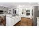 Modern kitchen with white cabinets, granite countertops, and stainless steel appliances at 151 Overhill Point, Alpharetta, GA 30005