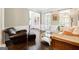 Inviting living room featuring hardwood floors, a leather chair, and ample natural light at 151 Overhill Point, Alpharetta, GA 30005