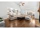 Spacious living room with hardwood floors, built-in shelving, and a view of the kitchen at 151 Overhill Point, Alpharetta, GA 30005
