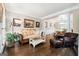 Bright living room with hardwood floors, decorative paintings, and an open plan leading into the dining area at 151 Overhill Point, Alpharetta, GA 30005