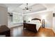 Spacious main bedroom featuring hardwood floors, a ceiling fan, and custom built-ins around the window at 151 Overhill Point, Alpharetta, GA 30005