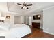 Main bedroom with tray ceiling, wood floors, and TV at 151 Overhill Point, Alpharetta, GA 30005