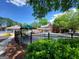Community pool surrounded by lush greenery, with a view of the clubhouse, seating, and grilling area at 151 Overhill Point, Alpharetta, GA 30005