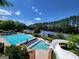 Aerial view of the community pool, water slide, and tennis courts on a sunny summer day at 151 Overhill Point, Alpharetta, GA 30005