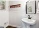 Stylish powder room with wainscoting, pedestal sink, and modern fixtures at 151 Overhill Point, Alpharetta, GA 30005