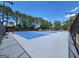 Tennis courts with new blue surfacing surrounded by lush trees at 151 Overhill Point, Alpharetta, GA 30005