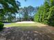 Sand volleyball court surrounded by grass and trees at 151 Overhill Point, Alpharetta, GA 30005