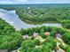 An aerial view of residences close to Lake Kedron, nestled in a lush green landscape on a clear, sunny day at 164 Interlochen Dr, Peachtree City, GA 30269
