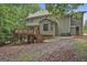 Exterior view of home with a wooden deck, and a lush, tree-filled backyard at 164 Interlochen Dr, Peachtree City, GA 30269