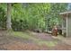 Backyard view featuring a wooden deck and mature trees, providing a private and natural setting at 164 Interlochen Dr, Peachtree City, GA 30269