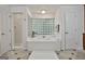 Elegant bathroom with a corner bathtub, separate shower, and glass block window at 164 Interlochen Dr, Peachtree City, GA 30269