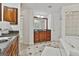 Bathroom featuring a soaking tub, tile floor, glass block window, and vanity with cabinet at 164 Interlochen Dr, Peachtree City, GA 30269