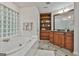 Bathroom featuring a soaking tub, tile floor, glass block window, and vanity with cabinet at 164 Interlochen Dr, Peachtree City, GA 30269