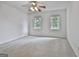 Bright bedroom featuring a ceiling fan and natural light from two windows at 164 Interlochen Dr, Peachtree City, GA 30269