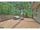Wooden deck featuring a modern patio set and a decorative stain pattern at 164 Interlochen Dr, Peachtree City, GA 30269