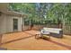 Wooden deck with a modern patio set, overlooks lush trees, and offers a relaxing outdoor space at 164 Interlochen Dr, Peachtree City, GA 30269