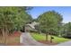 Home with a two-car garage, lush landscaping, and a private driveway at 164 Interlochen Dr, Peachtree City, GA 30269