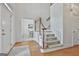 Bright foyer with hardwood floors, a staircase with white banisters, and views into other rooms at 164 Interlochen Dr, Peachtree City, GA 30269