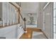 Bright foyer with hardwood floors, a staircase with white banisters, and views into other rooms at 164 Interlochen Dr, Peachtree City, GA 30269