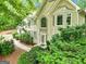 Beautiful front exterior view of the home surrounded by lush greenery and landscaping at 164 Interlochen Dr, Peachtree City, GA 30269