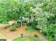 View of the home's front exterior nestled among mature trees and professionally landscaped surroundings at 164 Interlochen Dr, Peachtree City, GA 30269