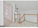 Bright hallway with light-colored carpet, white walls and trim, and natural wood handrail at 164 Interlochen Dr, Peachtree City, GA 30269