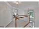 Upstairs hallway with staircase and view of the primary bedroom and natural light from the large picture window at 164 Interlochen Dr, Peachtree City, GA 30269