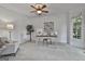 Bright home office featuring a ceiling fan, white walls, and plush carpeting at 164 Interlochen Dr, Peachtree City, GA 30269