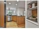 Bright kitchen offers stainless steel appliances, wood cabinets, hardwood floors and a breakfast nook at 164 Interlochen Dr, Peachtree City, GA 30269