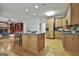 Open kitchen showcases an island with granite countertop, wooden cabinets, stainless appliances, and a breakfast nook at 164 Interlochen Dr, Peachtree City, GA 30269