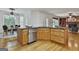 Kitchen island boasts stainless steel appliances, wooden cabinetry, and granite countertop with an eat-in dining area at 164 Interlochen Dr, Peachtree City, GA 30269