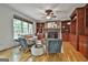 Cozy living room with hardwood floors, built-in bookshelves, and a stone fireplace at 164 Interlochen Dr, Peachtree City, GA 30269