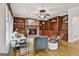 Spacious living room with built-in shelving, stone fireplace, and hardwood floors at 164 Interlochen Dr, Peachtree City, GA 30269