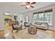 Bright living room with large windows, hardwood floors, and access to the kitchen at 164 Interlochen Dr, Peachtree City, GA 30269