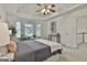 The primary bedroom offers bay windows, cozy sitting area and decorative artwork adding a touch of sophistication at 164 Interlochen Dr, Peachtree City, GA 30269