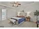 Bright main bedroom featuring a tray ceiling, ceiling fan, and neutral decor at 164 Interlochen Dr, Peachtree City, GA 30269