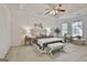 Relaxing primary bedroom featuring tray ceilings, large bay windows, carpeted floors and neutral decor at 164 Interlochen Dr, Peachtree City, GA 30269