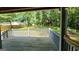 Spacious back yard with wood deck overlooking the fenced-in yard and wooded area with treehouse at 766 Virginia Cir, Forest Park, GA 30297