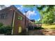 A view of the brick house's exterior, showing the back deck in the backyard at 766 Virginia Cir, Forest Park, GA 30297