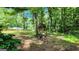 Backyard scene with a small wooden structure in the woods and a lush green lawn at 766 Virginia Cir, Forest Park, GA 30297