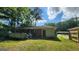 Exterior view of house featuring deck, foliage and lush green lawn in backyard at 766 Virginia Cir, Forest Park, GA 30297