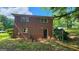 Two story brick house exterior with mature trees in backyard and chain link fence at 766 Virginia Cir, Forest Park, GA 30297