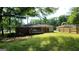 View of the exterior of house with a backyard with an elevated deck and fence at 766 Virginia Cir, Forest Park, GA 30297