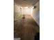 View of the unfinished basement featuring a light, A/C, and damaged flooring at 766 Virginia Cir, Forest Park, GA 30297